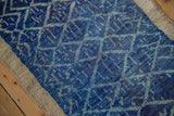 Distressed Oushak rug with cobalt and indigo blue lattice pattern and natural beige border.