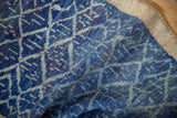 Textured vintage Oushak rug pile with cobalt and indigo lattice panels and heavy abrashes.