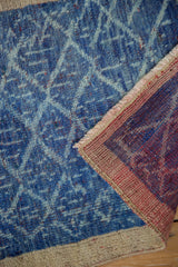 Distressed blue lattice pattern, natural beige border, and hand knotted rug reverse.