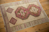 An angled view of the distressed Kars rug showing its full geometric pattern and worn texture.