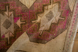 Folded corner of a vintage Kars rug showing the textured low pile and visible knot heads.