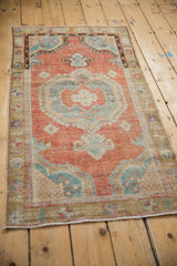 Angled perspective of the vintage distressed Oushak runner showing its full design and faded color palette.