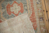 The hand-knotted foundation and tight weave on the reverse of a distressed vintage Oushak rug.