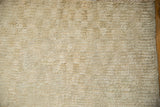 The varied texture of a vintage distressed Tulu rug showing pile and exposed knot heads.