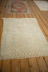 Varied, plush pile of a distressed Tulu rug, showing a subtle tone-on-tone checkered pattern.