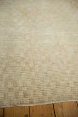 Close-up view of the distressed, nubby pile and visible knot heads of a vintage Turkish Tulu rug.