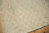 Detailed view of the soft ivory pile and hand-knotted foundation of a distressed Tulu rug.