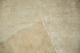 Hand-knotted foundation and textured ivory pile of a vintage distressed Tulu rug.