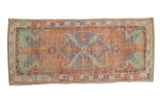 Distressed vintage Oushak rug runner, diamond medallion, serrated leaves in melon, blue, and green.