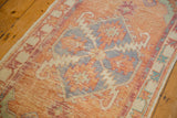 Distressed Oushak runner detail: faded blue medallion, cantaloupe leaves, mostly even wear.