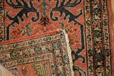 Folded corner of a vintage Mehreban rug reveals its hand-knotted back and ivory fringe.