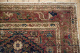 Dog-eared corner of a vintage Hamadan rug, with worn boteh border and threadbare selvage.