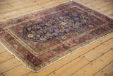 Vintage Hamadan rug's threadbare selvage and worn Herati design in burgundy and navy.