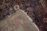 Dog eared corner of Hamadan rug, showing worn Herati pile and hand-knotted foundation.