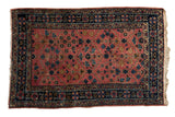 Vintage Persian Lilihan rug, dusty blush lattice floral field with navy blue double vine borders.
