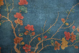 Detail of Art Deco rug: sprawling blossoms in dusty blush, copper, and jade green.