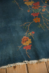 Fringed end of the blue vintage Art Deco rug, showing tatter.