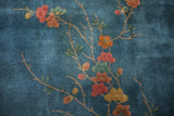 Art Deco blossoming branches in dusty blush, pale orange, and green on sky blue field.