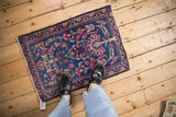 Antique Kerman rug with tree of life design in indigo and red, shown to scale.