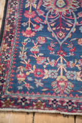 Fine hand-knotted detail of a Persian Kerman rug's dragon border and indigo floral field.