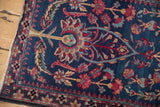 Detail of a dragon-style border and tree of life motifs on a fine antique Kerman rug.
