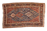 Antique fine Qashqai rug with a triple medallion in sapphire blue, chestnut, and ivory over a Herati style field.