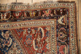 Hook and latch border details showing the hand-knotted texture of a fine antique Qashqai rug.