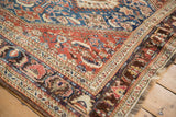 Corner detail of an antique Qashqai rug showing its sapphire blue field and complex border system.