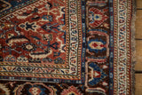 Intricate Herati-style borders and intact side cord selvage of a fine antique Qashqai rug.