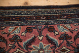 Vintage Bibikabad rug border, dusty cochineal red field, with meandering vine and boteh motifs.