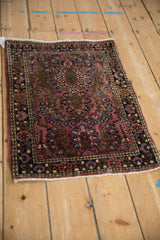Angled overhead view of the vintage Sarouk mat's unidirectional thousand flower design.