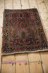 Angled view showing the unidirectional floral bouquet design of a vintage Sarouk rug.