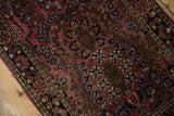 Detailed view of the vintage Sarouk's thousand-flower bouquet pattern and low pile.