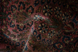 The soft texture of the hand-knotted pile and thousand flower design on a vintage Sarouk.