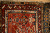 Stepped serrated leaf border of antique Northwest Persian rug in madder red, ivory, blue.