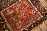 Madder red field and Herati motifs on antique Northwest Persian rug, with tattered end.