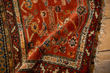 Antique Northwest Persian bagface rug: madder red field, stepped serrated border, plush wool pile.