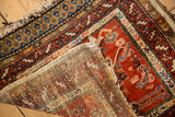 Antique Northwest Persian rug's sturdy foundation weave and soft red wool pile, showing motifs.