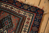 Antique Jaff Kurd rug corner, intricate borders of blue, red, ivory motifs, worn fringe.