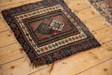Antique Jaff Kurd mat corner: blue and red geometric borders, repeating guls, tattered fringe.