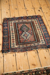 Antique Jaff Kurd rug corner with sapphire gul pattern, madder borders, and worn fringe.