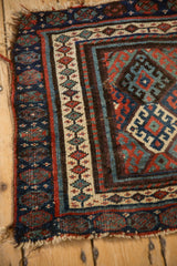 Antique Jaff Kurd rug corner with interconnected seed border, madder red, sapphire blue, and dusty green hues.