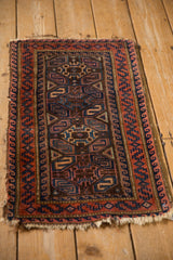 Belouch rug close-up: central geometric motifs, madder root red, cobalt blue.
