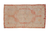 Distressed vintage Oushak runner, soft pale red medallion on ivory, geometric floral border.