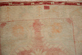 Even wear revealing faint foundation and faded red patterns on a distressed Oushak rug.