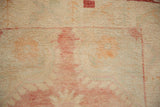 Distressed vintage Oushak rug pile texture with worn knot heads, faded ivory, pale red tones.