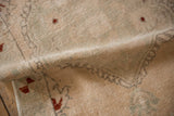 Worn pile of a distressed Oushak rug, showcasing cream, dusty seafoam, and subtle rust.