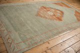 Vintage Kars carpet's terracotta geometric border detail and faded slate blue field.