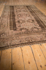 Distressed Anatolian carpet showing wear to foundation, chocolate brown border, dusty rose motifs.