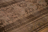 Worn chocolate brown field of a vintage Anatolian rug with dusty rose Samovar medallions.